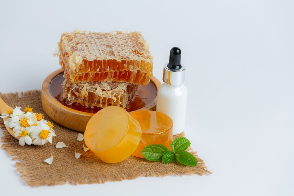 A natural honey soap bar placed on a clean surface, used as a nourishing soap for skin whitening.

