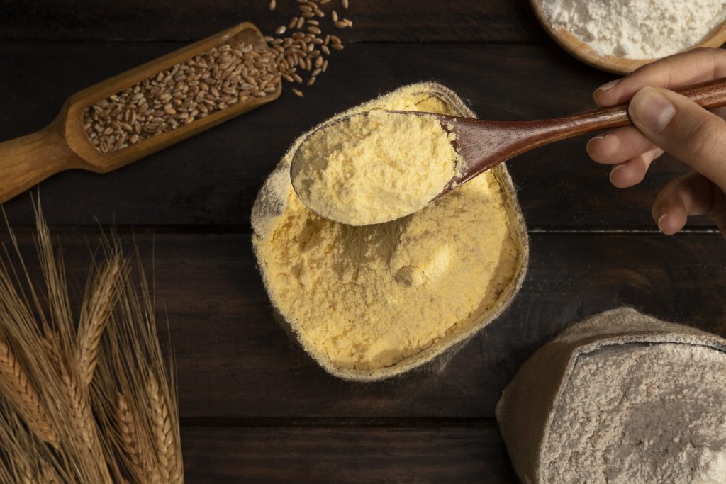 A bowl with a flour and turmeric mixture, commonly used in natural remedies to get rid of black neck.

