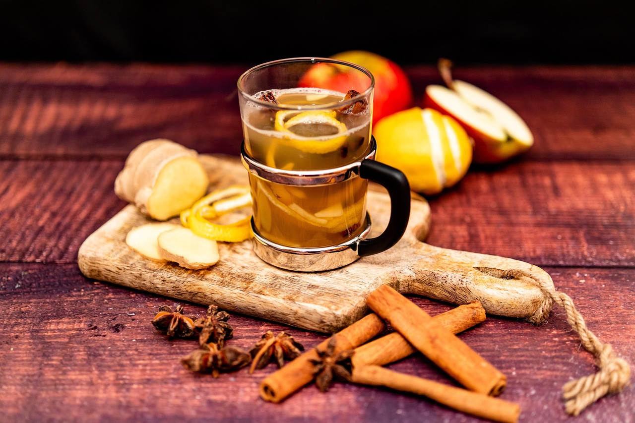A clear glass filled with apple cider vinegar on a wooden table