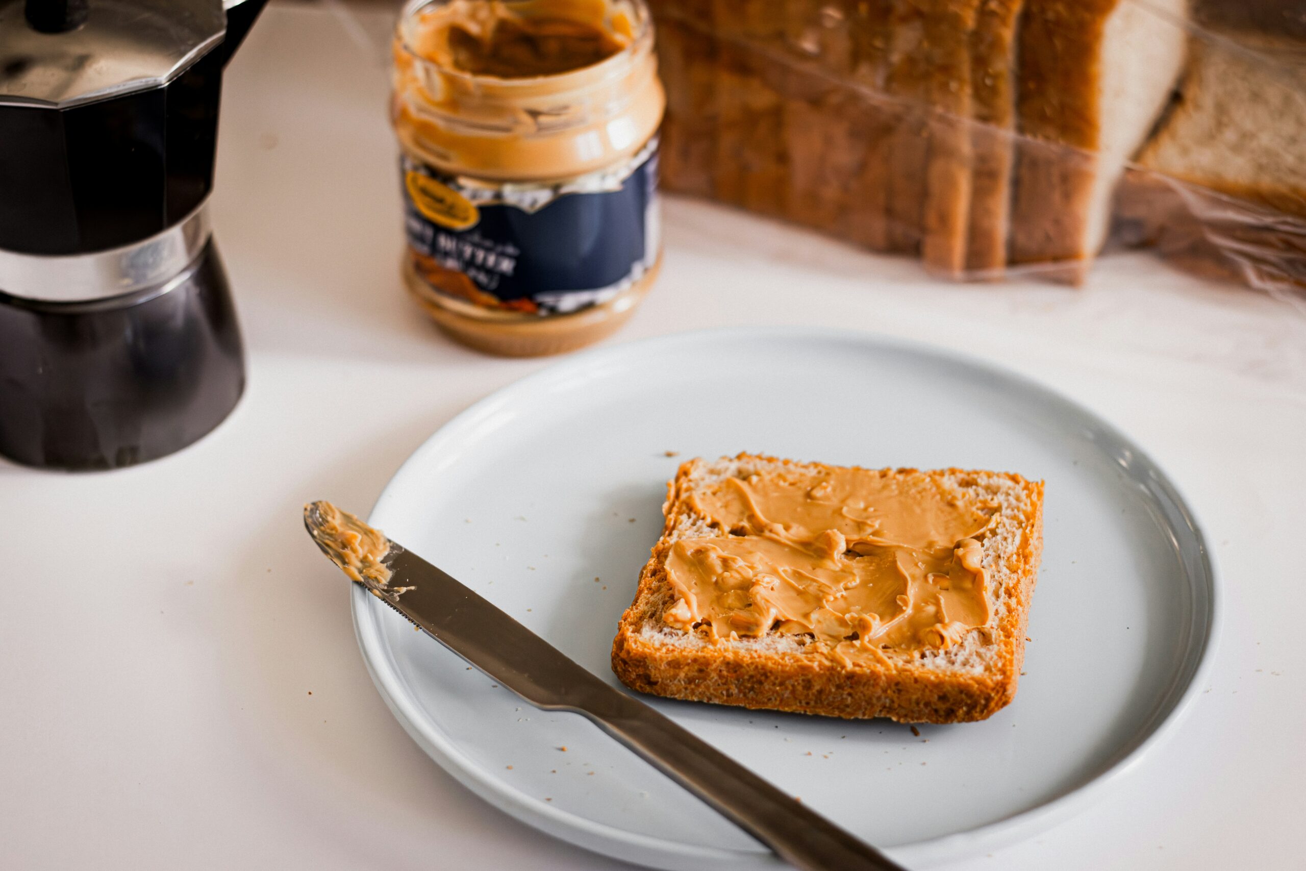 Almond butter vs peanut butter comparison for weight loss showing nutritional facts and health benefits side by side